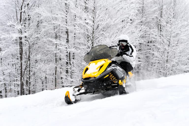 snowmobiling through the winter wonderland is one of the best things to do in Minnesota in the winter