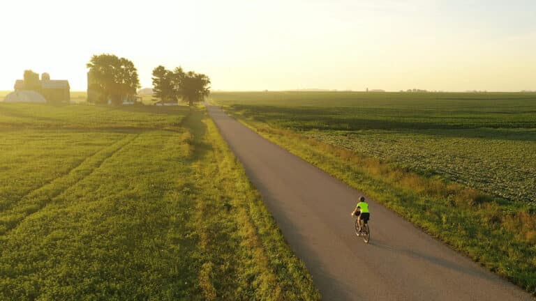Someone biking in the wide open countryside on one of the best bike trails in Wisconsin
