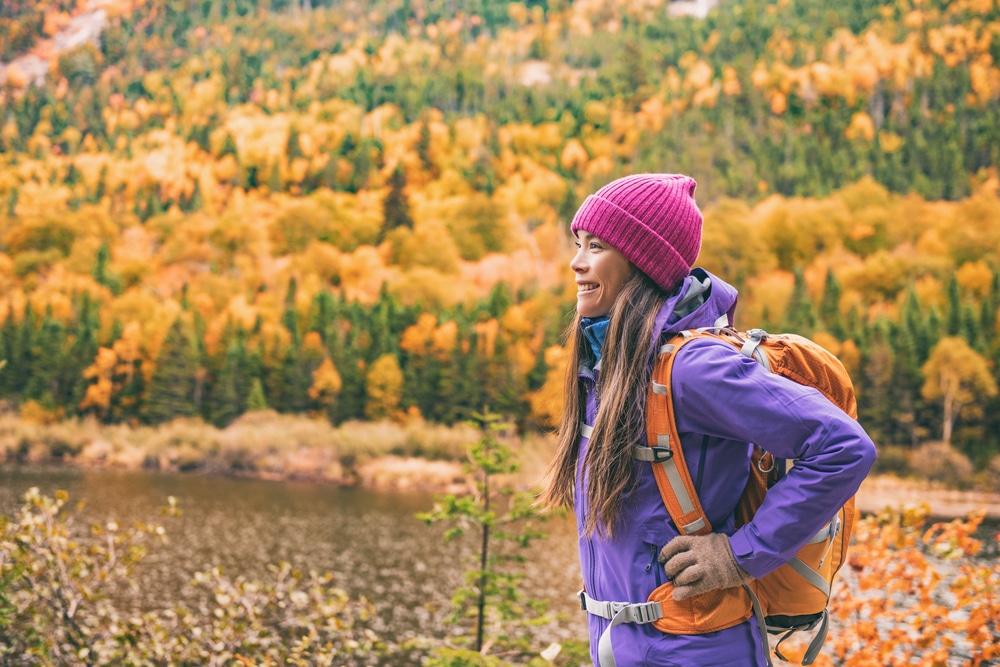 Woman hiking and taking in the beauty of fall colors in Wisconsin