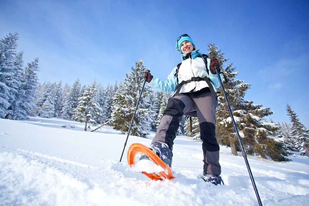WunderRoost Bed and Breakfast 3 Woman snowshoeing through the woods - one of the best things to do in La Crosse, WI in the winter