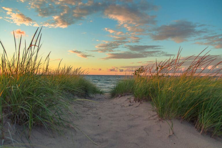 A pathway through the dunes at a Lake Michigan Beach - a great way to enjoy summer weekend getaways in the Midwest