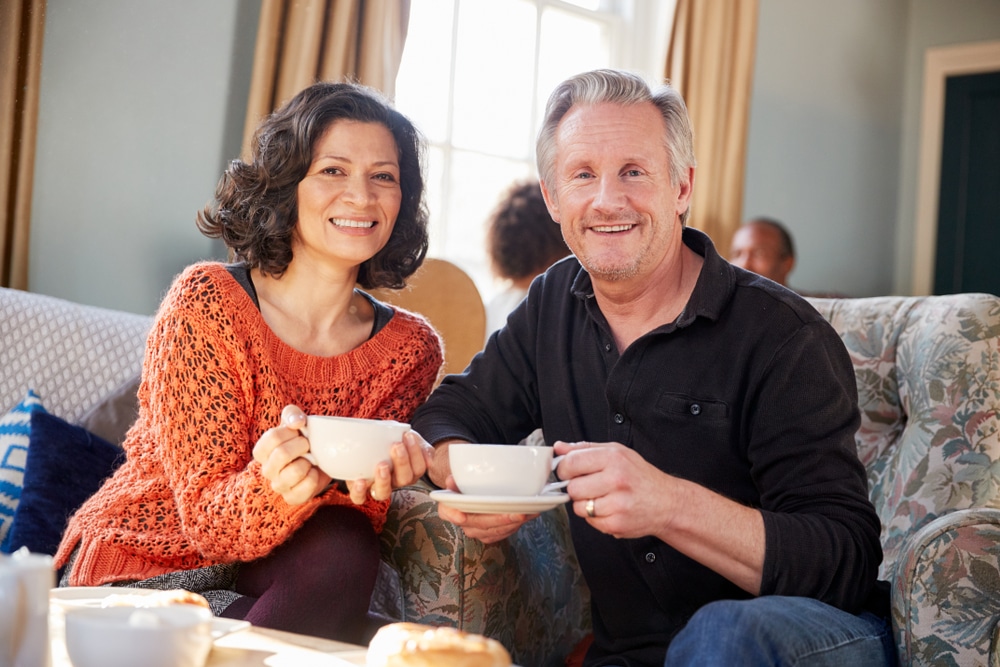 middle aged couple enjoying coffee at one of the best places to stay in the Midwest this fall