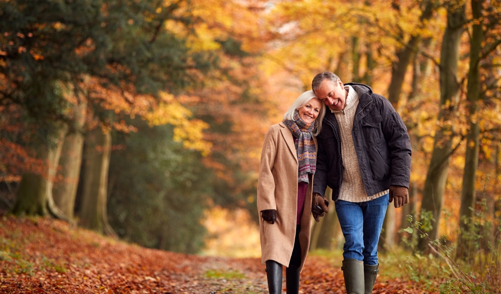 Couple enjoying a walk through fall foliage while enjoying the best things to do in Dubuque, Iowa