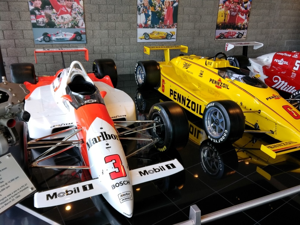 Race cars on display at a museum similar to the Museum of American Speed in Lincoln, Nebraska