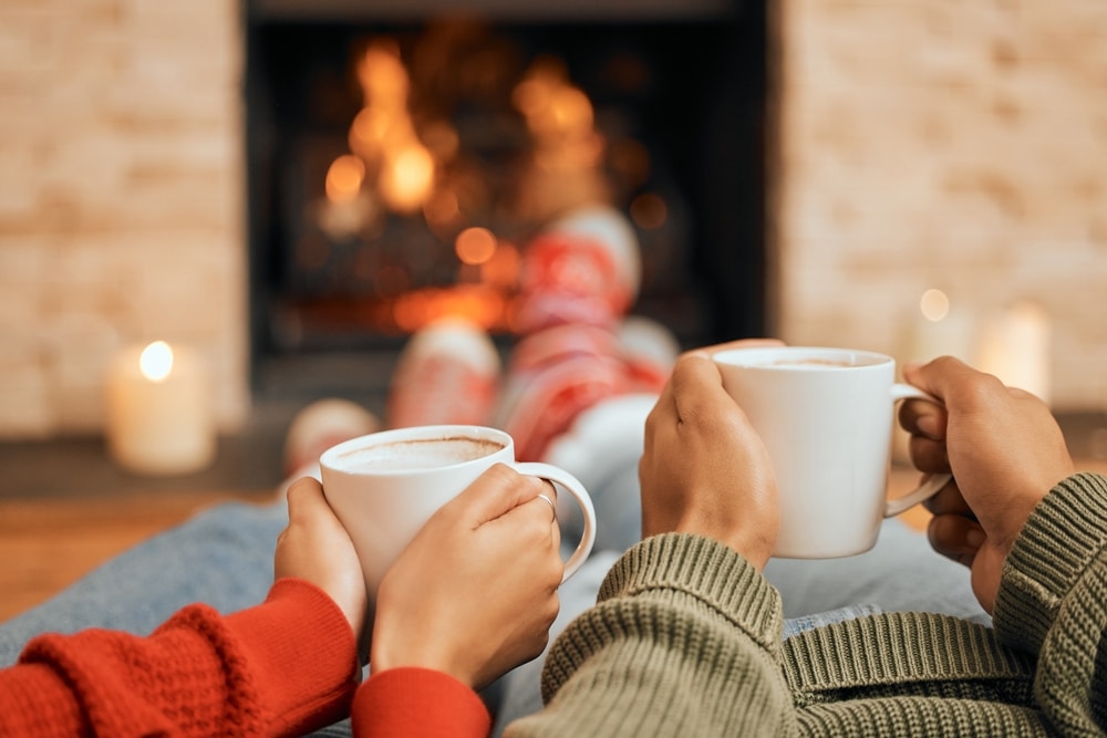 Couple drinking coffee by the fire at the best Lodging in the Midwest