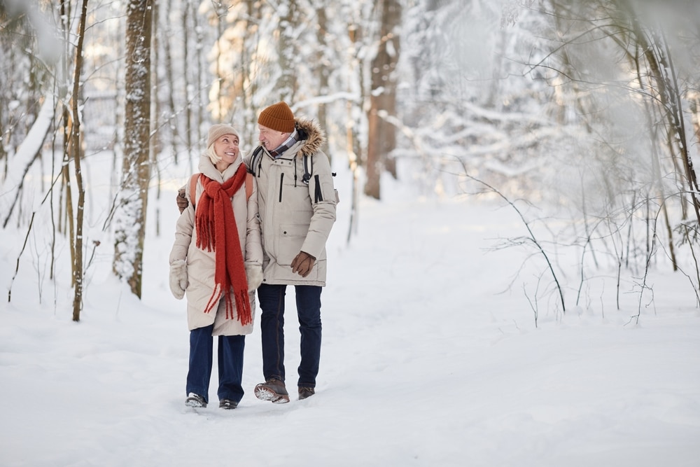 Couple enjoying a romantic winter walk while enjoying some of the best places to stay in Minnesota