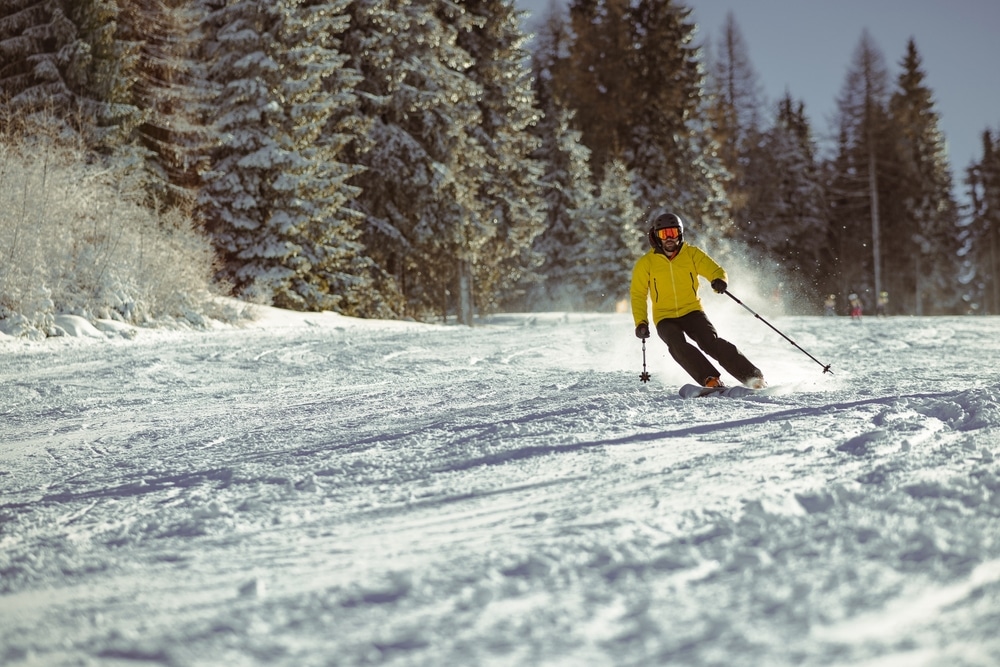 Man skiing at places like Lutsen Mountains Minnesota - one of the best Midwest ski resorts