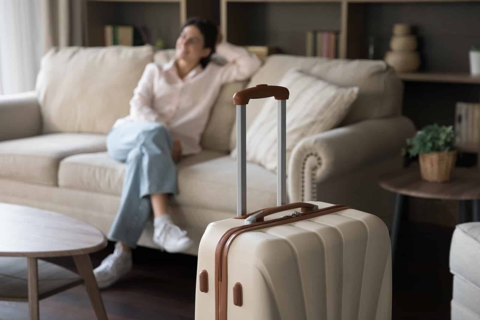 Woman sitting on a guest room at a boutique Inn, including some of the best places to stay in St. Paul, Minnesota