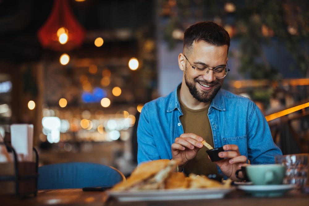 This Year's Best Restaurants in St. Paul, Minnesota! 6 Man enjoying a burger at local restaurants in St. Paul
