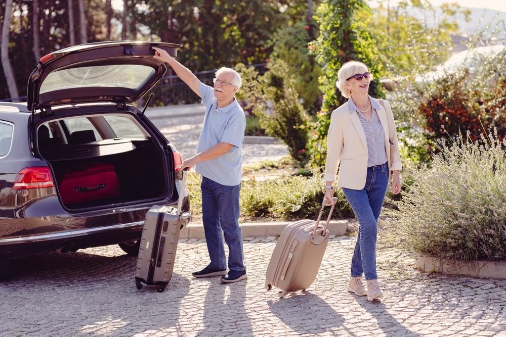 Find the Best Weekend Trips From Minneapolis 18 Couple taking luggage out of their car as the enjoy the best weekend trips from Minneapolis