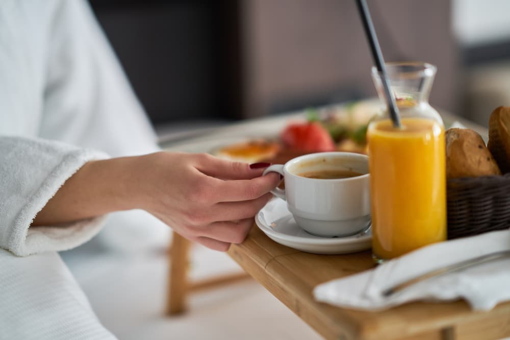 Woman enjoying breakfast in bed at an Iowa Bed and Breakfast near Pikes Peak State Park