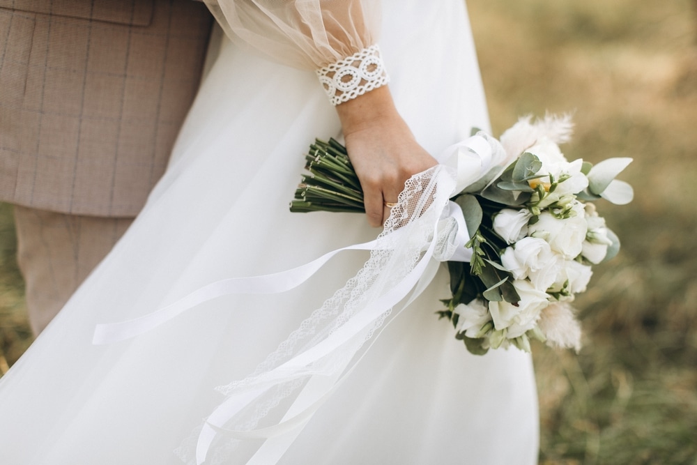 Couple holding a bouquet at outdoor unique wedding venues in the midwest