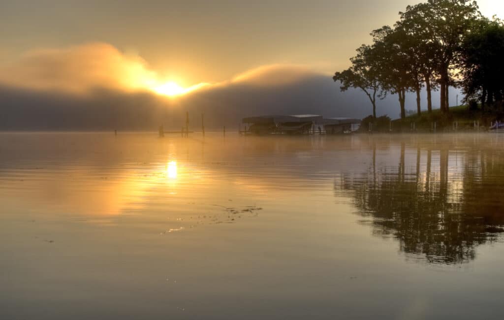 Photo of a sunrise over a lake in Okoboji, one of the best places to visit for weekend getaways in Iowa