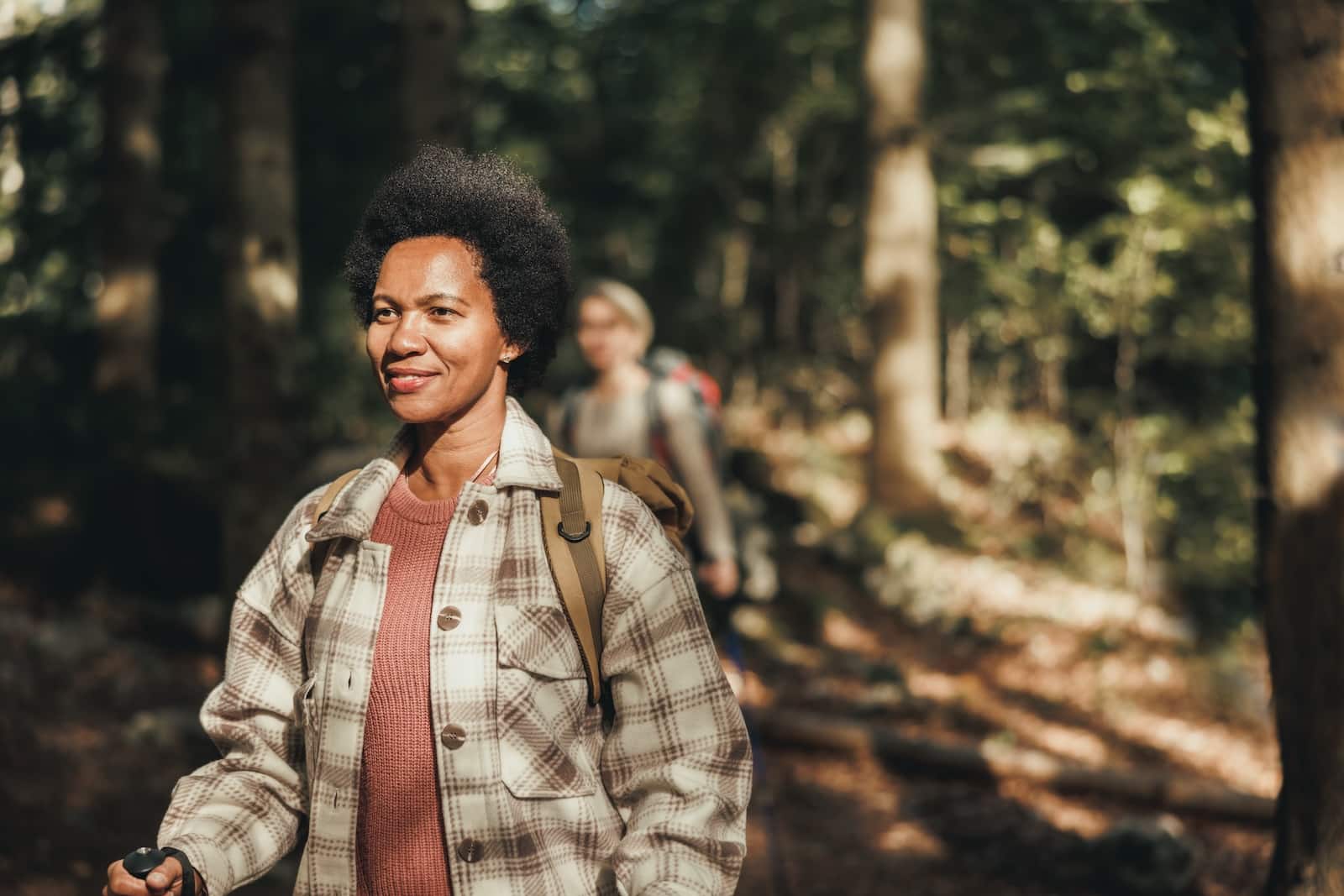 Mature black woman hiking on mountain Devil's Lake State Park